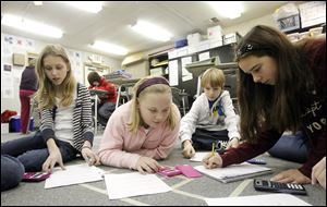 From left, Allison McNulty, Rose Nygard, Adam Ohls, and Nicole Dibling team up in Karen Schrock's 6th-grade math class.
