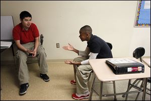 Byrnedale math students Yi Lu, left, and Tylan Crowley discuss their stocks. Each team chooses four stocks worth $5 a share and has a hypothetical $40,000 budget to purchase their shares. 