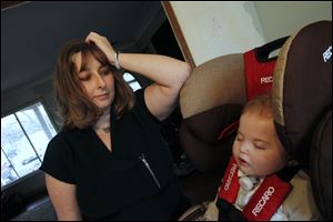 Crystal Tenney watches her son Caysen sleep after coming home from C.S. Mott Children's Hospital. Caysen has spent nearly his entire life in hospitals because of a condition with his esophagus.