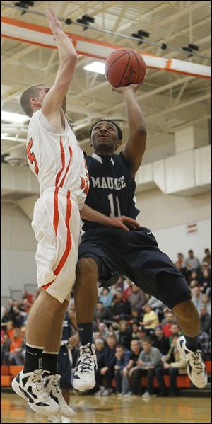 Maumee Valley's Julius Turner, right, takes a shot against Gibsonburg's Gage Beaber on Tuesday. Turner had 18 points, including three 3-pointers in a 75-53 Toledo Area Athletic Conference matchup between the league's top two teams.
