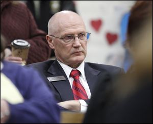 State Rep. Rick Olson of Saline listens as the board explains that state funding cuts for education made the district cuts necessary.