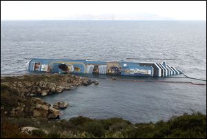 The grounded cruise ship Costa Concordia lies off the Tuscan island of Giglio, Italy.