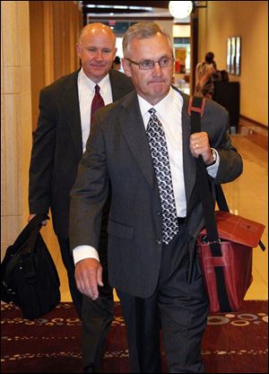 Former Ohio State football coach Jim Tressel arrives for a hearing in Indianapolis in this Aug. 12, 2011, photo. He was there to testify about his role in NCAA violations that shook the foundation of Ohio State's powerhouse football program and cost him his job.  