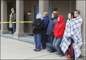 Spectators on the streets watch as pieces of the Seneca County Courthouse clock tower fall. Demolition of the tower was delayed for several days because of an equipment failure.