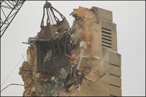 A crane dismantles the 107-foot clock tower that stood above Seneca County's 1884 courthouse.
