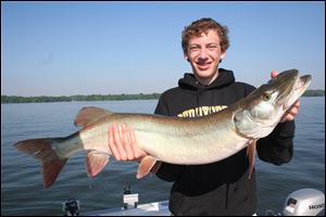 A beaming Jake Lederer shows off his 42-inch muskie took last summer after a 20-minute test of his skills at Alum Creek Reservoir.