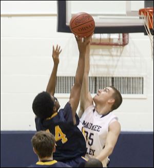 Maumee Valley's #35, Jared Sturt, blocks the shot of Toledo Christian's #14, Damon St. John.