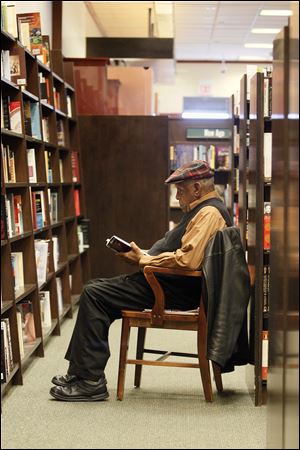 Toledoan James Sansbury reads a book at Barnes & Noble, which is opening another location at Dorr and Secor.