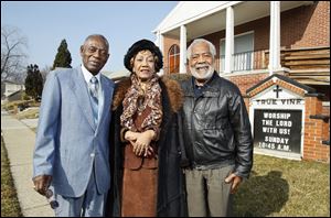 Robert Harris, Bellzora Duhart, and Norman Bell gather outside True Vine Missionary Baptist Church. Mr. Bell, father of Toledo’s mayor, says he moved north to do what was best for his family and himself.