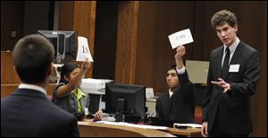 Sylvania Southview student Clement Dupuy, right, is timed as he questions a 