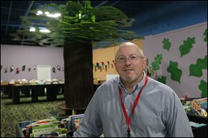 Patrick Borden of Temperance looks in the children's section of Ukazoo, which specializes in mostly used books and some new. Almost all are priced $6 or less. Ukazoo started selling books online in 2002 and opened its first store in Maryland in 2007.