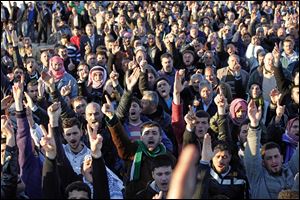 Anti-government protesters chant slogans during the funeral of two comrades killed in earlier clashes in Idlib, north Syria. Russia and China vetoed a U.N. Security Council resolution aimed at ending Syria's bloodshed, despite international outrage Saturday over a devastating bombardment of the city of Homs by President Bashar Assad's forces.