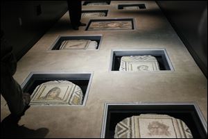 Made with tiny pieces of chiseled stone and glass to depict birds and faces, the 12 mosaics at the Wolfe Center for the Arts at BGSU were first believed to be from authorized excavations in Antioch, Turkey, overseen by Princeton University.