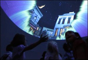 Preschoolers view ‘One World, One Sky: Big Bird’s Adventure,’ a production by the Sesame Workshop. The mobile planetarium show was presented Tuesday at the Toledo-Lucas County Head Start center on Steadman Street in Toledo.