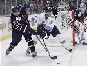 The Walleye’s Paul Zanette, 9, defends against South Carolina’s Brett Flemming. Zanette was named Walleye player of the week after recording one goal and three assists last week at Kalamazoo.