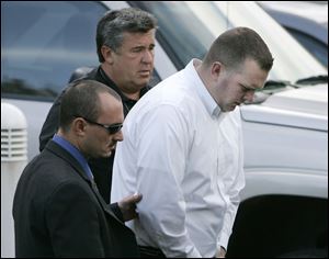 Former Lucas County corrections officer Seth Bunke is escorted from federal court in Toledo, Ohio, Oct. 14, 2008. He was charged with assaulting inmates at the Lucas County Jail.