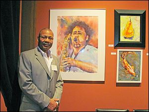 Aaron Bivins with some of his artwork at 20 North Gallery.