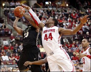 Purdue's Lewis Jackson, left, goes to the basket as Ohio State's William Buford defends during the first half Tuesday night in Columbus. Buford, a Libbey graduate, had a career-high 29 points to move past Toledoan Jim Jackson into sixth place in OSU career scoring.