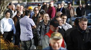 People wait in line during a job fair for Home Depot at the WorkSource Oregon in Tigard, Ore. 