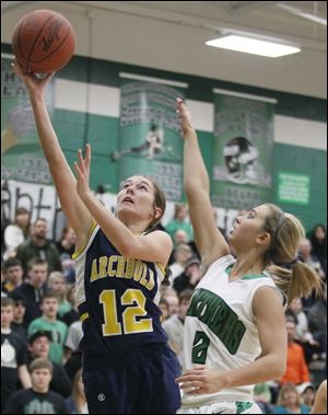 Archbold's Chelsea Goebel (12) goes to the net against  Delta's Bri Raab. Goebel scored 10 points for the 19-0 Blue Streaks.