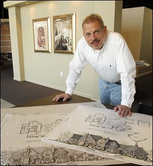 Joe St. Jean, in his Maumee office with his design for a 7,200-square-foot home to built in Maryland, said he focuses on the needs of his clients for a functional and aesthetically pleasing home.