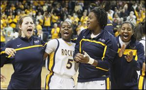 Toledo's Anna Capotosto, left, Janelle Reed-Lewis, Brianna Jones, and Mariah Carson after the Rockets beat the Falcons 52-50. 