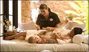 A mother and child enjoying a family spa treatment at Aulani on Oahu, Hawaii. At Disney's new family resort and spa, the Laniwai Spa also offers special family suites where babies can accompany parents and young children can have massages.