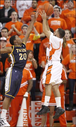 University of Toledo player Julius Brown, 20, defends as Bowling Green State University Jordan Crawford, 1, puts up a shot during the first half at the Stroh Center at Bowling Green State University, Saturday.