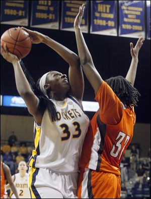 Toledo's Yolanda Richardson shoots over Bowling Green's Alexis Rogers. Richardson carried the Rockets in the second half by scoring 10 points. Toledo has beaten BG three straight years.