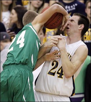 Archbold's Luke Kammeyer (24), right,  defends against Delta's Justin Callahan (24) Friday, Feb. 10.