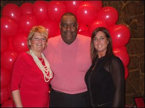 Volunteer co-chairmen Debbie Katich, left, and Dana Mollenkamp, right, with James Caldwell, president and CEO of the Toledo Northwestern Ohio Food Bank, at the Valentine's Day benefit dance.