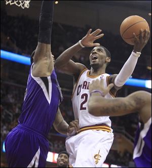 The Cavaliers' Kyrie Irving jumps to the basket against the Kings' DeMarcus Cousins, left, in the fourth quarter.