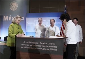 Secretary of State Hillary Rodham Clinton and Mexico's Foreign Minister Patricia Espinosa, sign the US-Mexico Agreement Concerning Transboundary Hydrocarbon Reservoirs in the Gulf of Mexico, Monday in Los Cabos, Mexico. 
