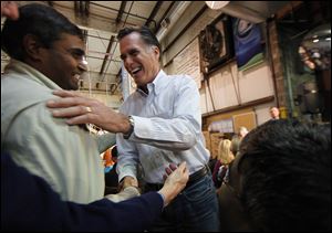 Republican presidential candidate Mitt Romney greets employees at Meridian Bioscience in Cincinnati. He cited the company's owner Monday for taking a risk in founding the firm and then leading its growth. 
