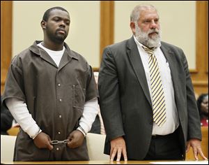 Byron Mitchell, with attorney Pete Rost, is sentenced to nine years in prison by Judge Gene Zmuda, in Lucas County Common Pleas Court.  He previously entered an Alford plea to involuntary manslaughter with a gun specification and was found guilty in the shooting death of Eric Daniels on July 3, 2011.