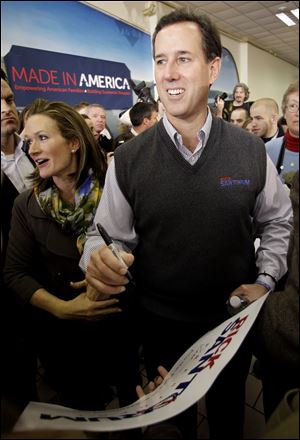 Republican presidential candidate, former Pennsylvania Sen. Rick Santorum, accompanied by his wife Karen, visit with supporters at Froehlich's Classic Corner Monday in Steubenville, Ohio.