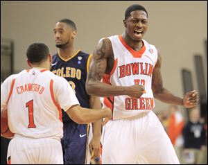 Bowling Green State University players Torian Oglesby, 32, and Jordon Crawford, 1, celebrate on the court. Oglesby's enthusiasm has been a driving force in the Falcons success this season.