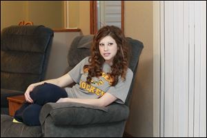 Alyssa Batch of Clay High School watches the video of the MTV show 'Made' at her home in Curtice, Ohio. The show chronicles young people experimenting with a new hobby or sport they wouldn't normally try. For Alyssa, that sport was hockey. 