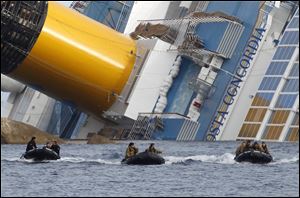 Italian Navy scuba divers return after working on the grounded cruise ship Costa Concordia off the Tuscan island of Giglio, Italy.