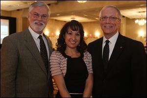 Mingling at the Rotary Club of Perrysburg's Charity Auction were co-chairmen Wayne Koskinen, left, and Rick Thielen with club president Julie Roberts.