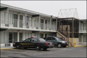 A perrsyburg Police cruiser parked at the Econolodge in Perrysburg where two people were found dead.