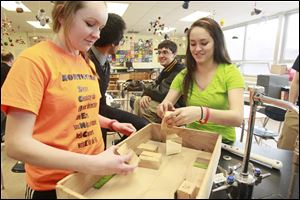 Katelyn Work and Marissa Milliron, members of the Northview High School Science Olympiad,  construct an optics box for a competition. The club has 42 members. The regional tournament will be March 3 at Ohio State University's campus in Lima, Ohio. 