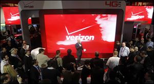 Consumer Electronics Show attendees check out the unveiling of 4G devices at the Verizon booth in Las Vegas last month.