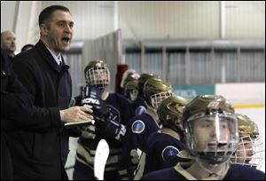 St. John’s coach Mike Hayes directs his team behind the bench in a sectional game against Whitmer. The Titans are 24-9-1 and ranked sixth in Ohio. They finished second to Northview in the Northwest Hockey Conference Red Division.