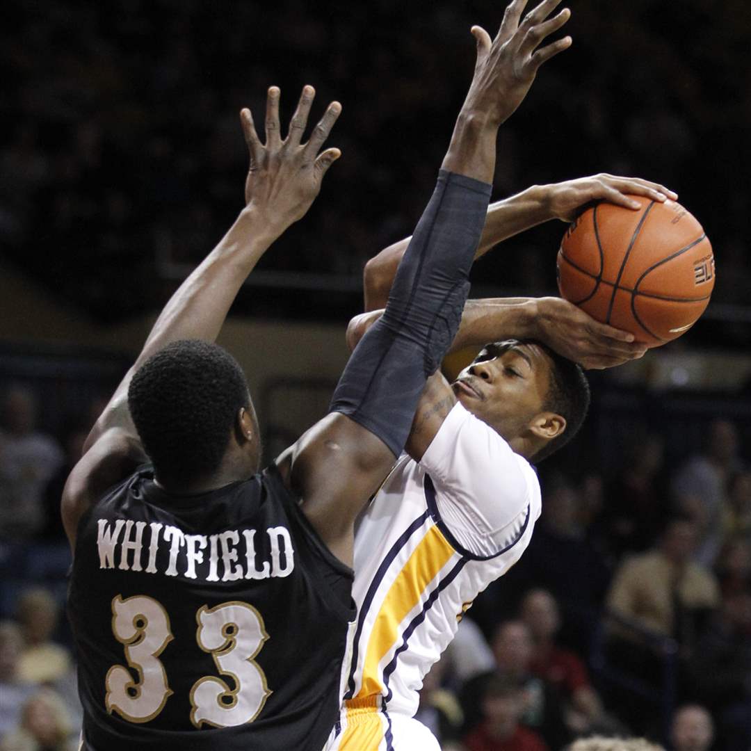 University-of-Toledo-player-Julius-Brown-20-puts-up-a-shot-against-Western-Michigan-player-Flenard-Whitfield-33