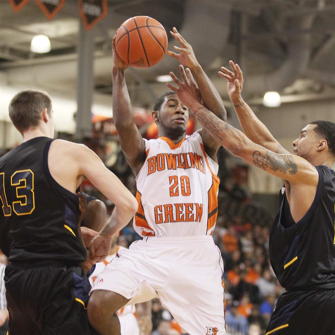 BGSU-s-Jehvon-Clarke-looks-to-pass-between-Kent-State-s-Mark-Henniger