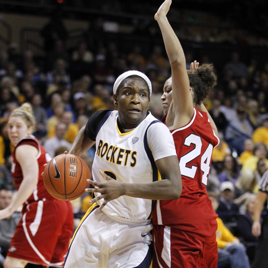 UT-player-Lecretia-Smith-drives-around-NIU-s-Kim-Davis-in-the-1st-half