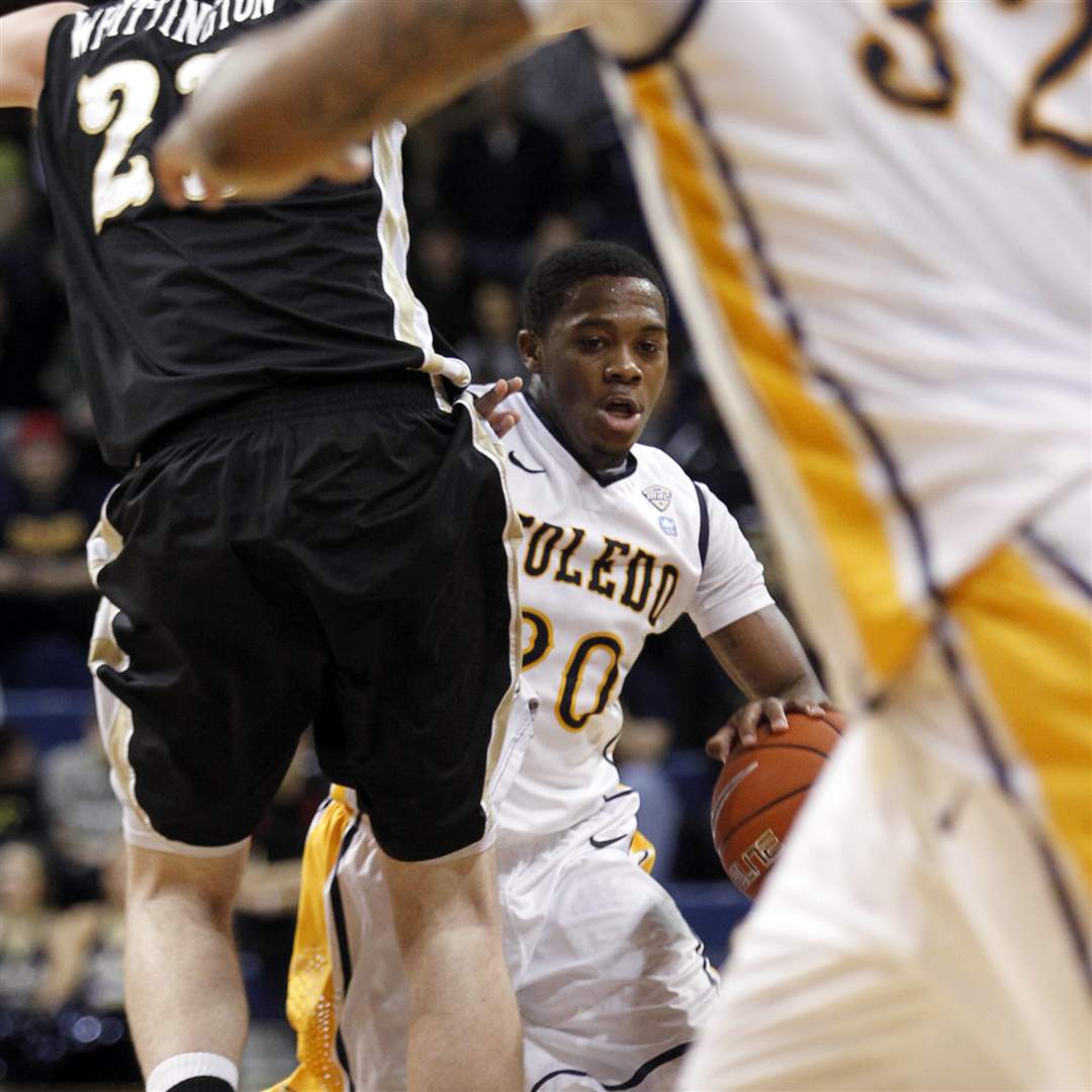 University-of-Toledo-player-Julius-Brown-tries-to-find-room-around-Western-Michigan-player-Shayne-Whittington