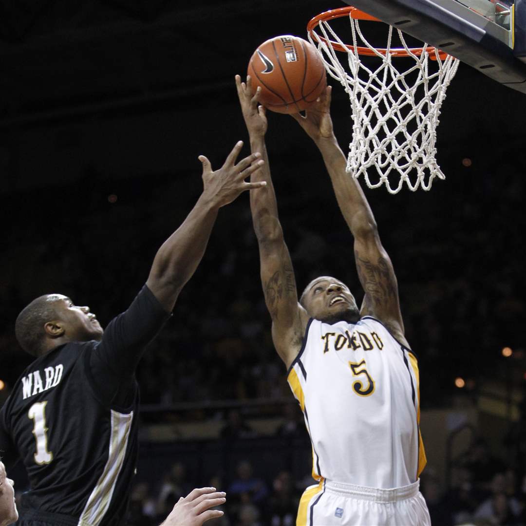 University-of-Toledo-player-Rian-Pearson-5-soars-past-Western-Michigan-player-Demetrius-Ward
