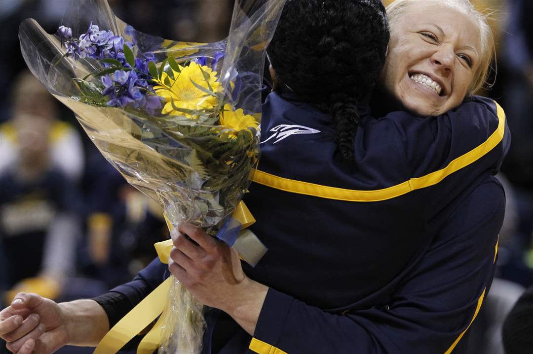 UT-s-Haylie-Linn-gets-a-hug-from-teammate-Lecretia-Smith-on-Senior-Night